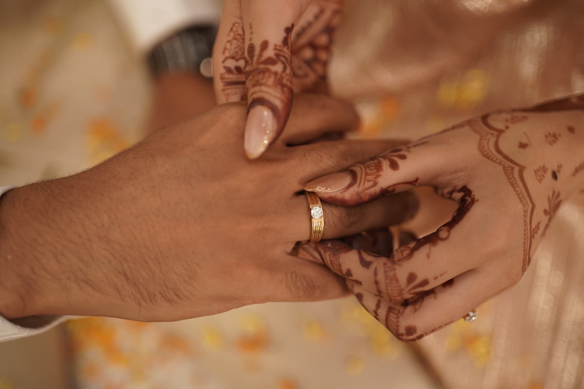 Nancy placing a ring on Mayank's hand